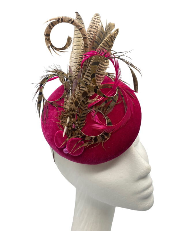 Stunning pink velvet headpiece with an array of beautiful feathers.